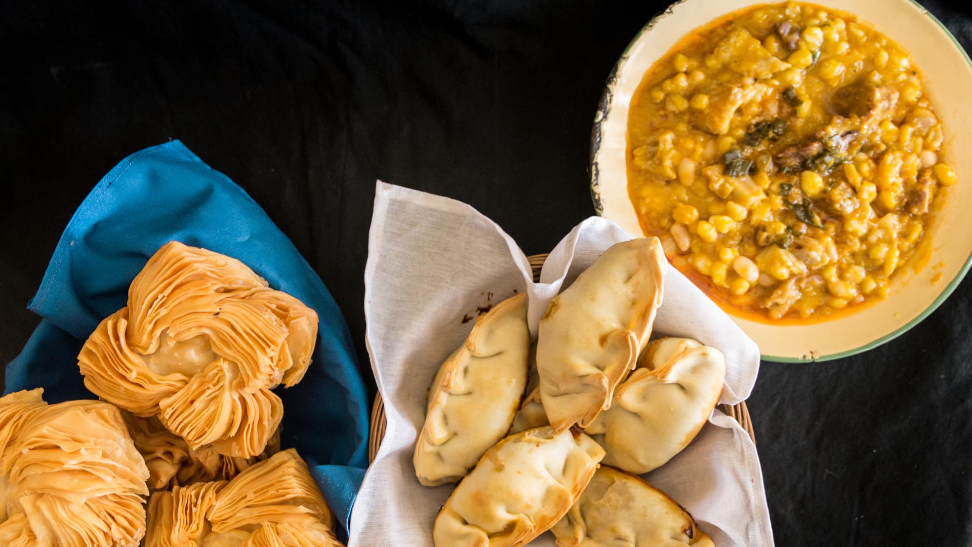 dishes of locro empanadas and sweet pastries, traditional Argentine foods that are frequently consumed for national holidays, such as the revolution of May 25 and independence on July 9