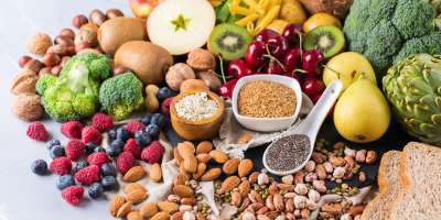 Healthy balanced dieting concept. Selection of rich fiber sources vegan food. Vegetables fruit seeds beans ingredients for cooking. Copy space background